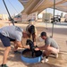 U.S. Airmen bathe U.S. Air Force deployed therapeutic support dog