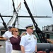Ms. Amanda Bowman attaches shoulderboards for Captain Jenkins