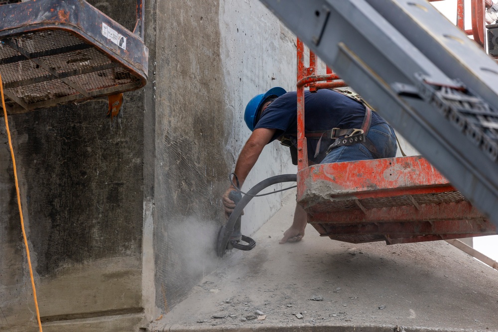 Chipping away old concrete to preserve Montgomery Dam piers for the future