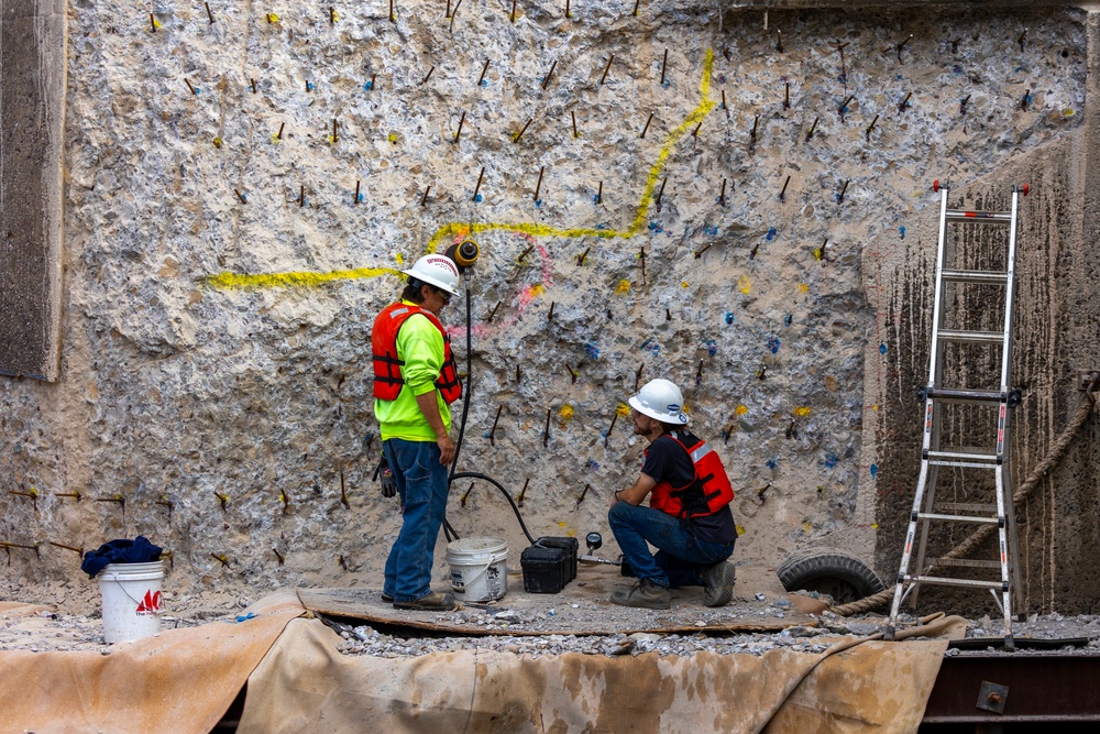 Chipping away old concrete to preserve Montgomery Dam piers for the future