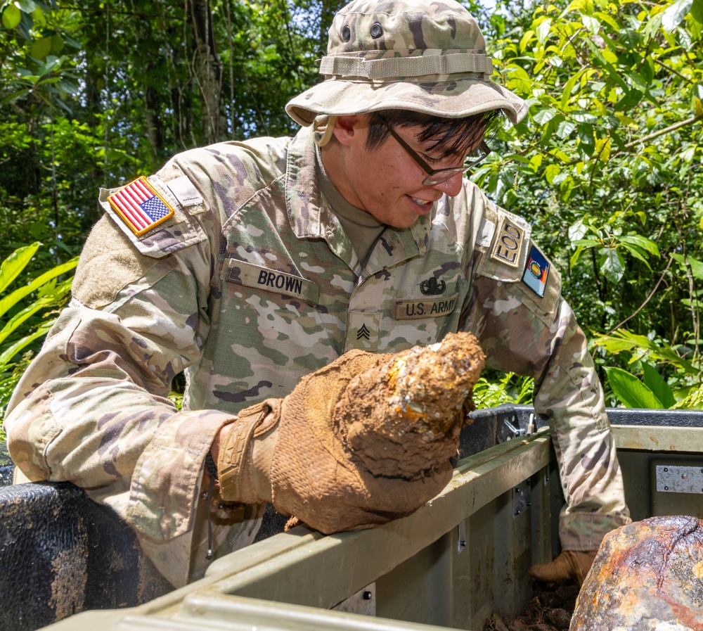 EOD team of joint service members conduct reconnaissance in Munda