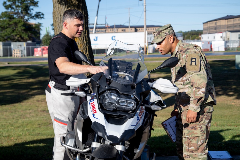 Motorcycle Mentor Inspects Bike with Rider