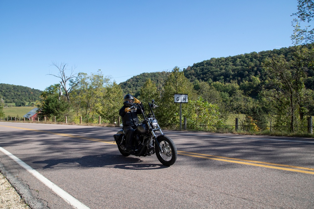 Soldier Rides By on Motorcycle