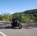 Soldier Rides By on Motorcycle