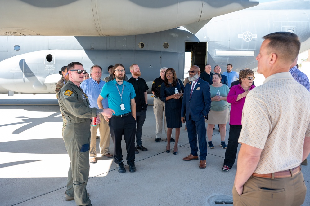 Public religious leaders are briefed by a Kirtland Airman before touring a MC-130J