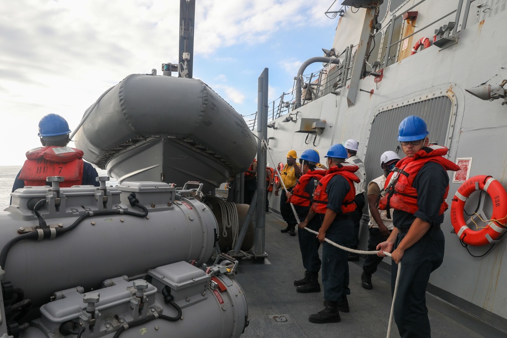 Sailors aboard the USS Howard conduct a small boat operation in the South China Sea