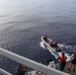 Sailors aboard the USS Howard conduct a small boat operation in the South China Sea