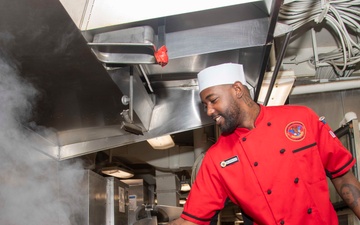 USS Carl Vinson Sailor Prepares Food in the Galley