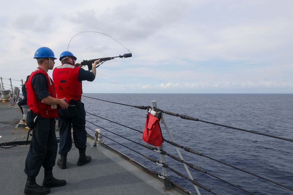 Sailors aboard the USS Howard conduct a replenishment-at-sea with the HMNZS Aotearoa in the South China Sea