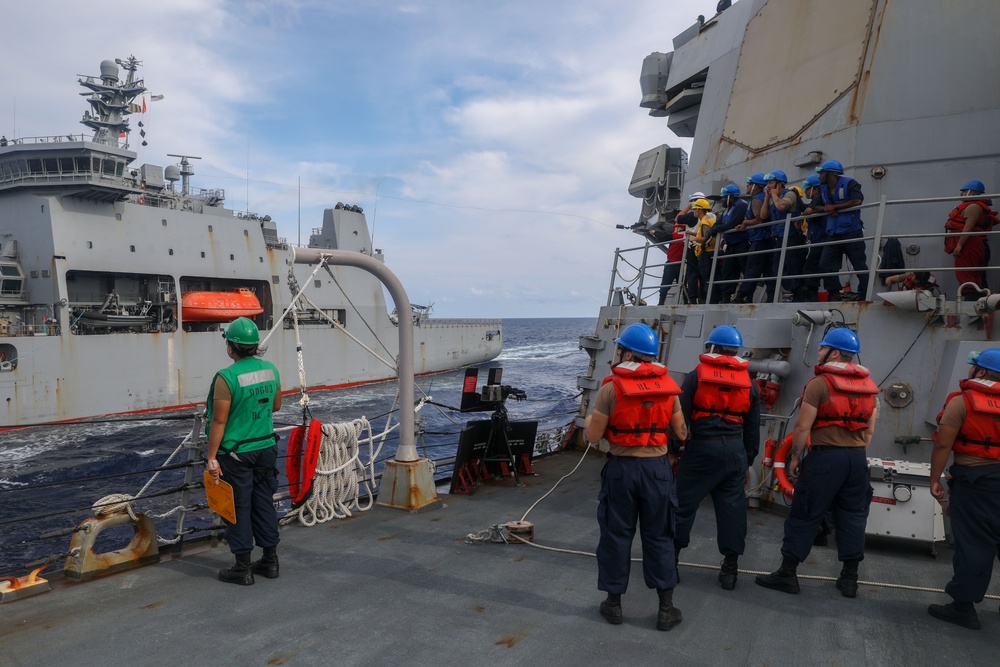 Sailors aboard the USS Howard conduct a replenishment-at-sea with the HMNZS Aotearoa in the South China Sea