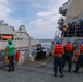 Sailors aboard the USS Howard conduct a replenishment-at-sea with the HMNZS Aotearoa in the South China Sea