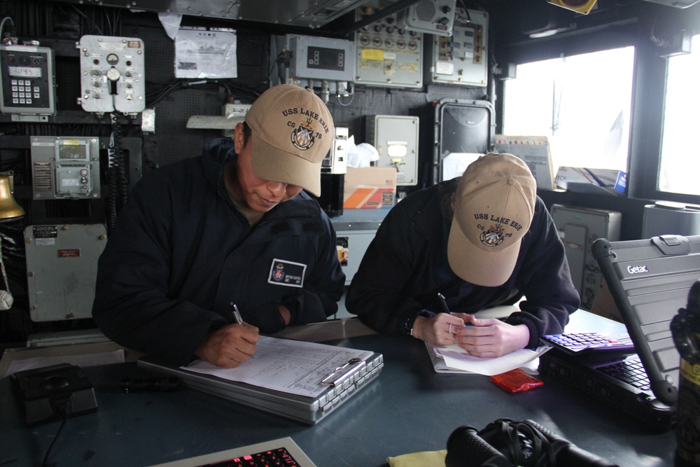 Quartermasters stand watch aboard USS Lake Erie (CG 70) in the Northern Pacific Ocean