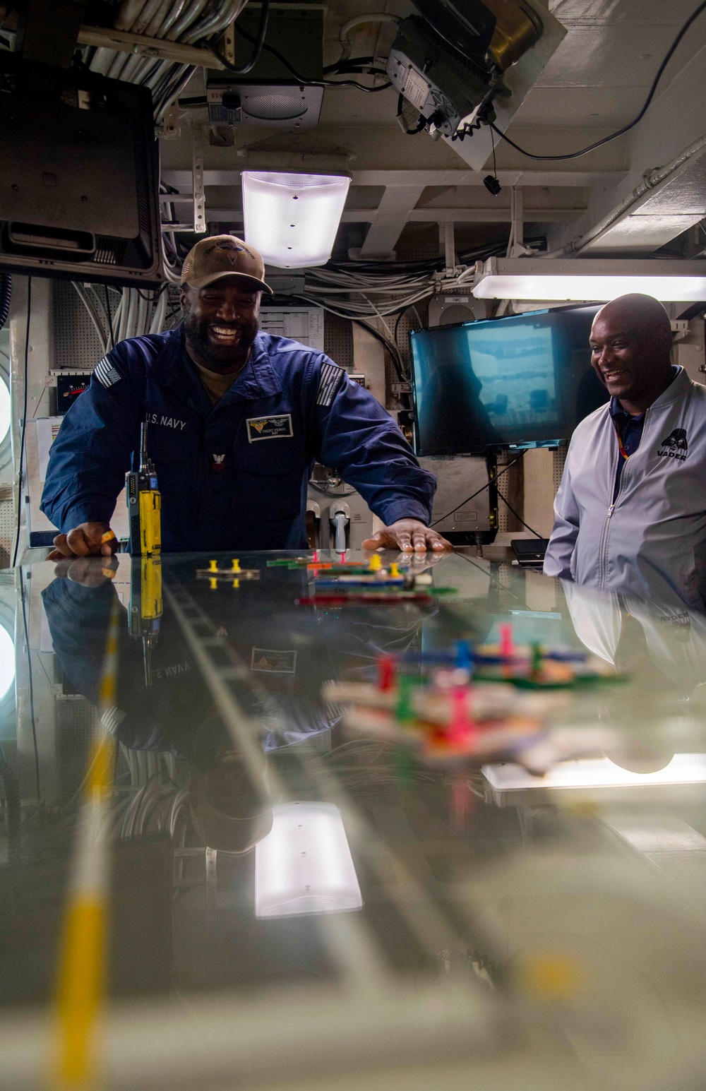 Sailor speaks to members of the Royal Australian Air Force in flight deck control aboard Nimitz-class aircraft carrier USS Carl Vinson (CVN 70).