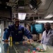 Sailor speaks to members of the Royal Australian Air Force in flight deck control aboard Nimitz-class aircraft carrier USS Carl Vinson (CVN 70).