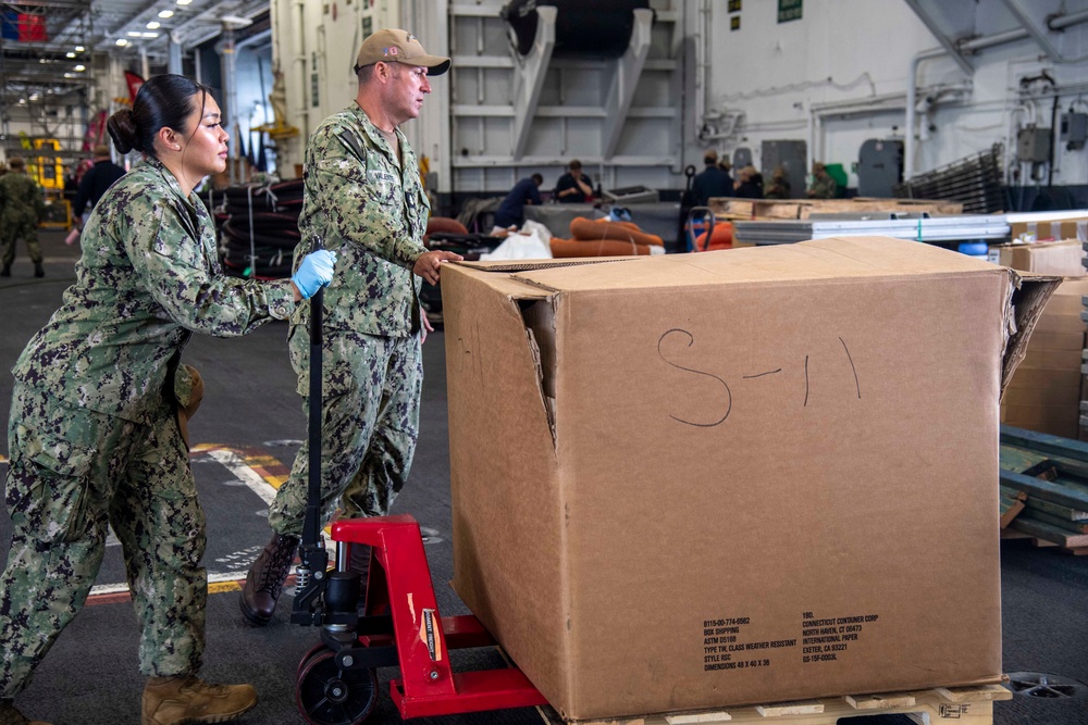 Sailors Move Supplies Aboard USS Carl Vinson (CVN 70)