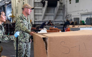 Sailors Move Supplies Aboard USS Carl Vinson (CVN 70)