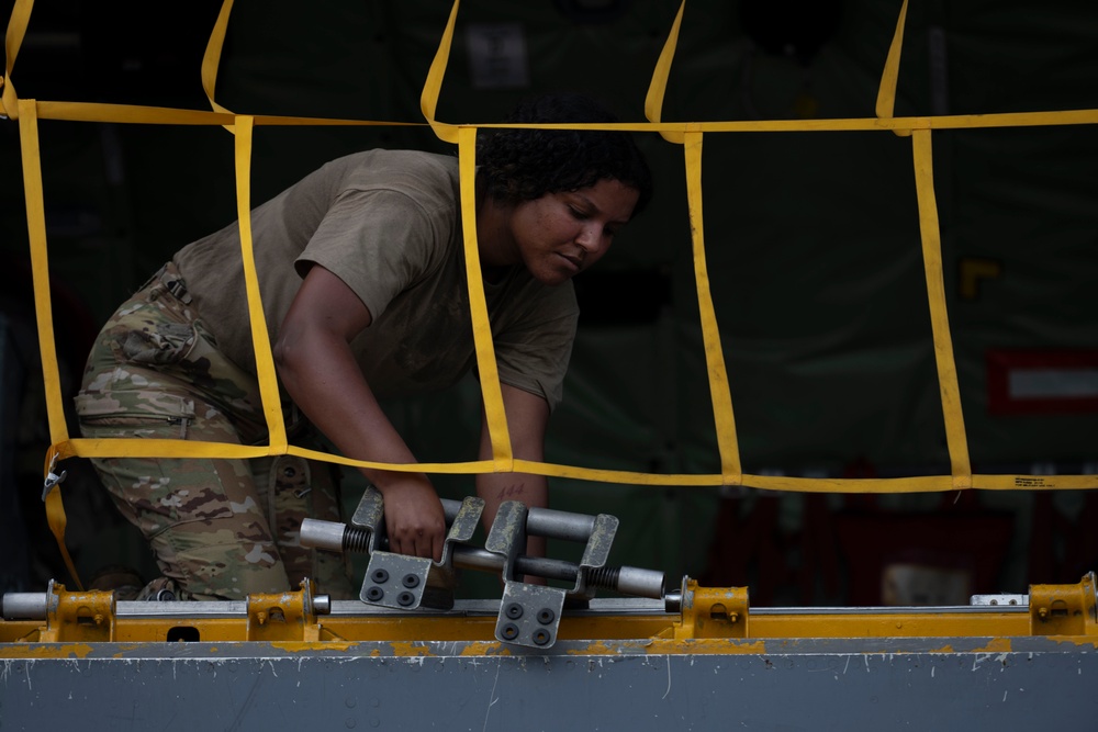 Boom operators prepare for cargo load