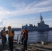 Sailors aboard the USS Howard conduct a passenger transfer with sailors aboard the HMAS Sydney V in the South China Sea