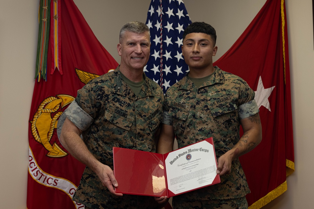 Brigadier General Collins Congratulates Marine of the Quarter