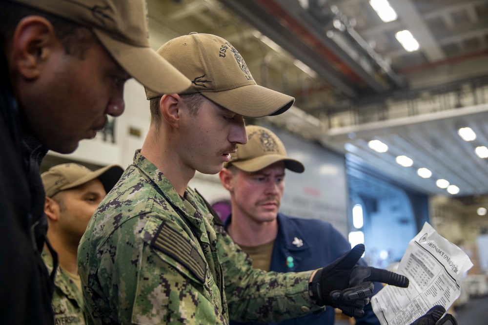 Tripoli Sailors Bring Ammo Onboard