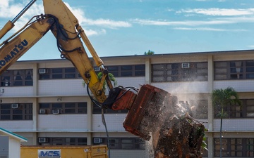 Out With The Old, In With The New: Construction workers prepare to demolish the Mackie Hall barracks