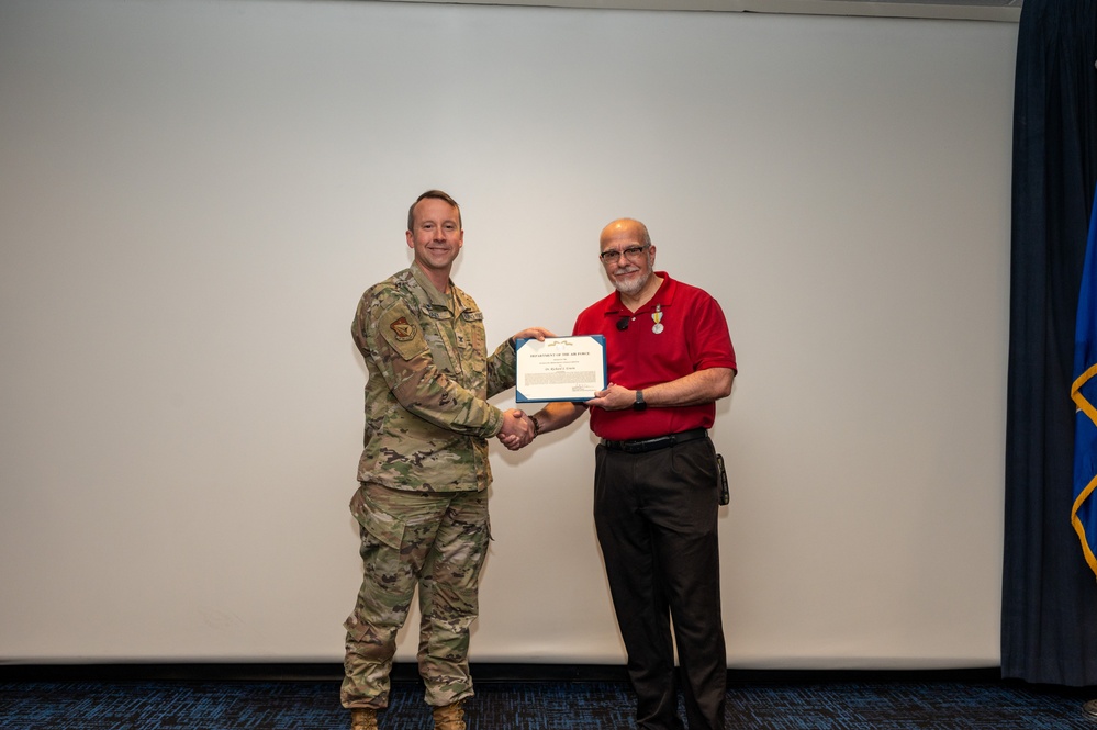 U.S. Air Force Col. Jeremy Raley, Space Vehicles Directorate commander awards Dr. Richard Erwin, Space Vehicles Directorate chief scientist the meritorious service award.