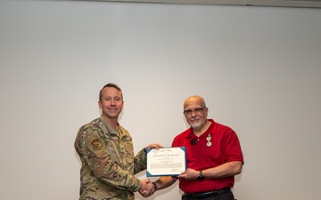 U.S. Air Force Col. Jeremy Raley, Space Vehicles Directorate commander awards Dr. Richard Erwin, Space Vehicles Directorate chief scientist the meritorious service award.