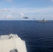 Sailors aboard the USS Howard conduct a passenger transfer with sailors aboard the HMAS Sydney V in the South China Sea