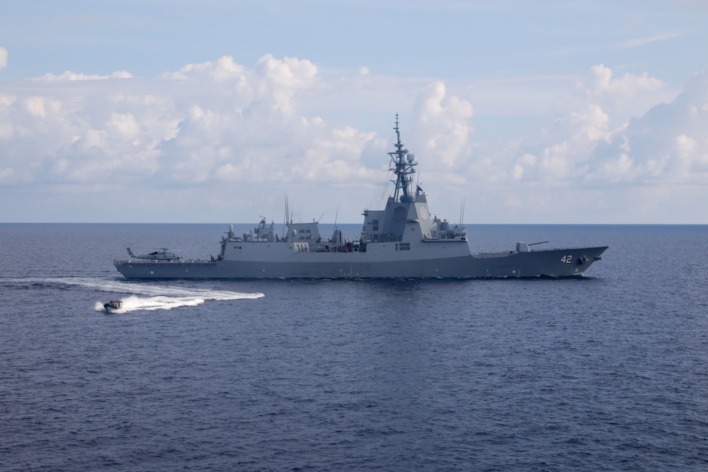 Sailors aboard the USS Howard conduct a passenger transfer with sailors aboard the HMAS Sydney V in the South China Sea