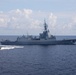 Sailors aboard the USS Howard conduct a passenger transfer with sailors aboard the HMAS Sydney V in the South China Sea