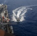 Sailors aboard the USS Howard conduct a passenger transfer with sailors aboard the HMAS Sydney V in the South China Sea