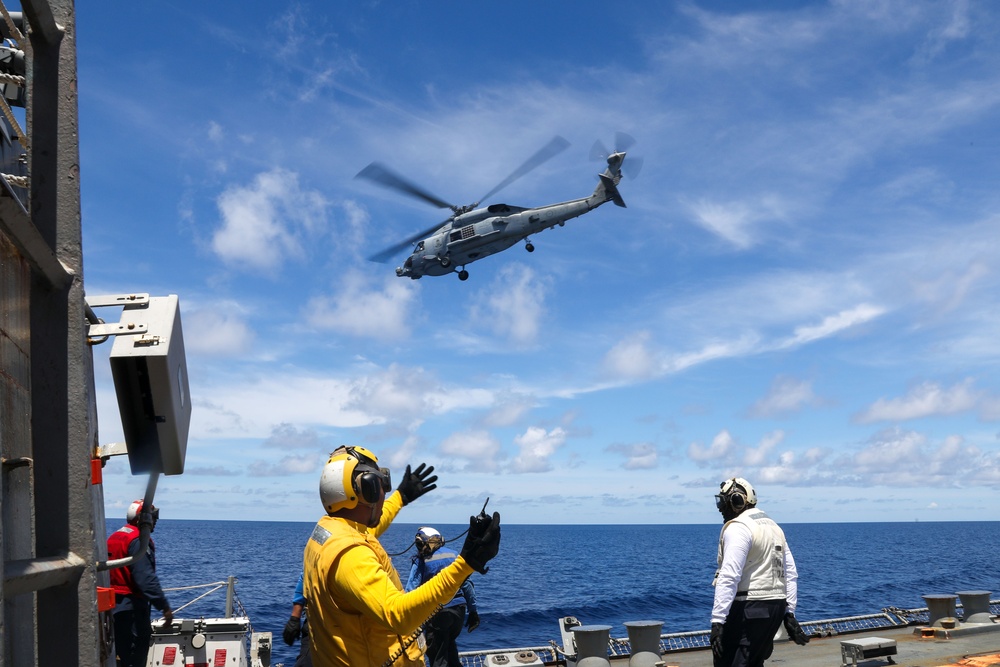 Sailors aboard the USS Howard conduct flight quarters with an MH-60R Sea Hawk helicopter as part of an exercise with the HMAS Sydney V in the South China Sea