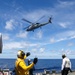 Sailors aboard the USS Howard conduct flight quarters with an MH-60R Sea Hawk helicopter as part of an exercise with the HMAS Sydney V in the South China Sea