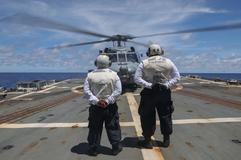 Sailors aboard the USS Howard conduct flight quarters with an MH-60R Sea Hawk helicopter as part of an exercise with the HMAS Sydney V in the South China Sea