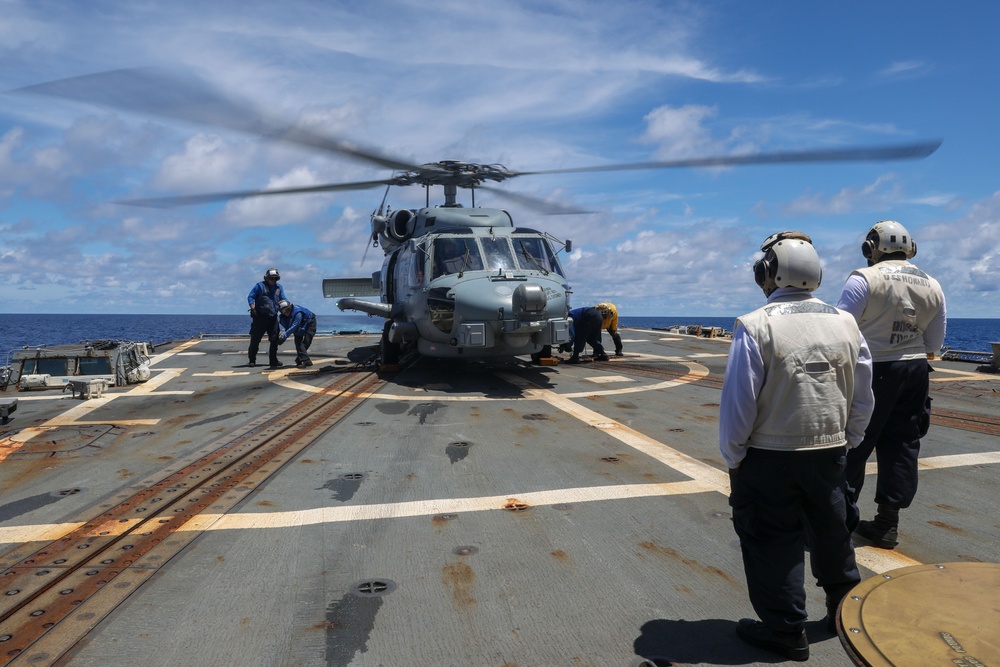 Sailors aboard the USS Howard conduct flight quarters with an MH-60R Sea Hawk helicopter as part of an exercise with the HMAS Sydney V in the South China Sea