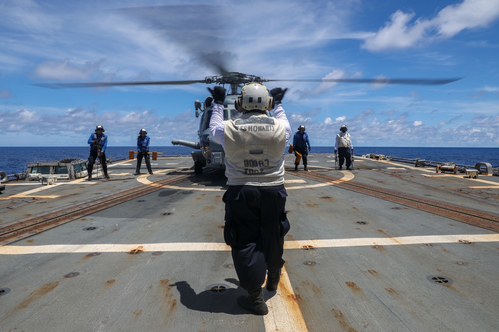 Sailors aboard the USS Howard conduct flight quarters with an MH-60R Sea Hawk helicopter as part of an exercise with the HMAS Sydney V in the South China Sea