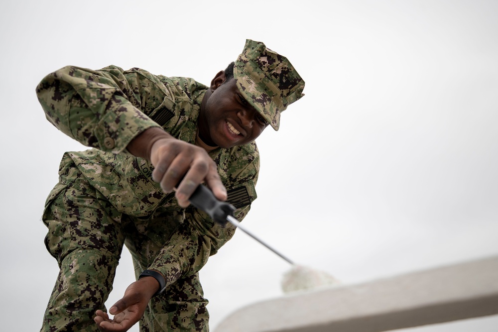 USS Tripoli Sailors Preform ship maintenance