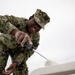 USS Tripoli Sailors Preform ship maintenance