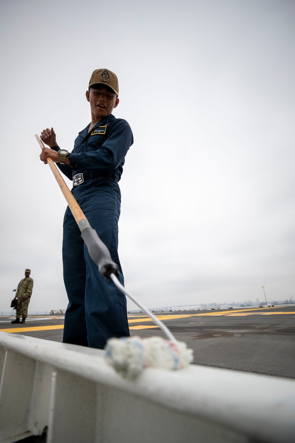 USS Tripoli Sailors Preform ship maintenance