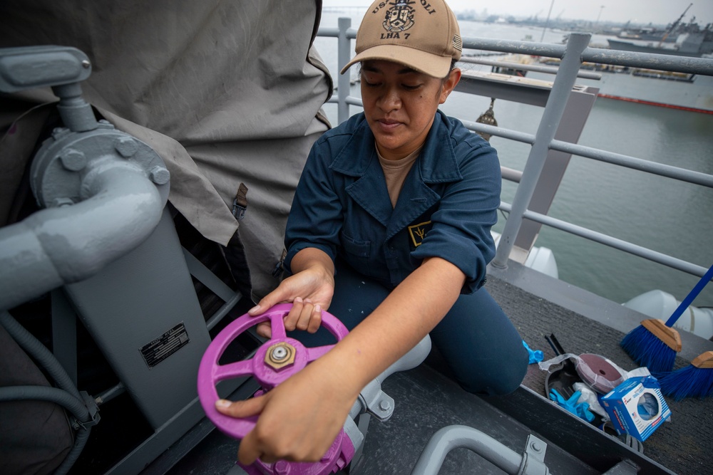 USS Tripoli Sailors Preform ship maintenance