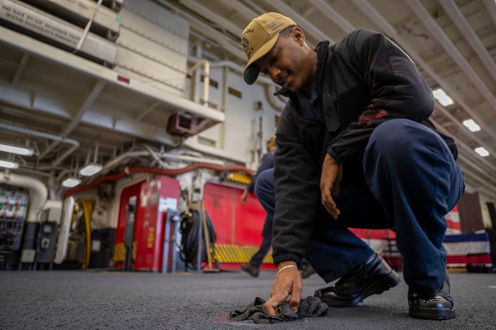 USS Tripoli Sailors Preform ship maintenance