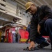 USS Tripoli Sailors Preform ship maintenance