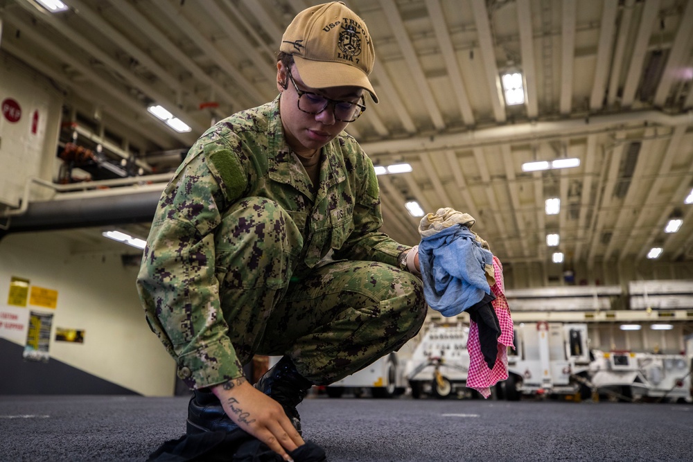 USS Tripoli Sailors Preform ship maintenance