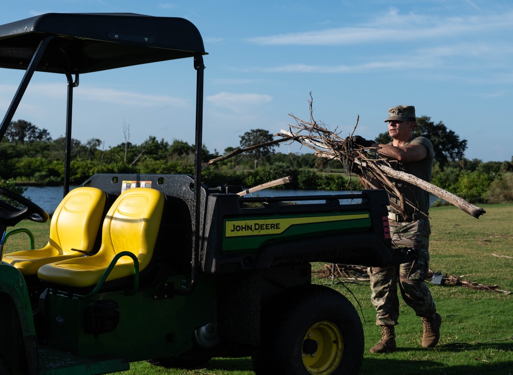 Volunteers and Staff clean up MacDill AFB Golf course following Hurricane Helene
