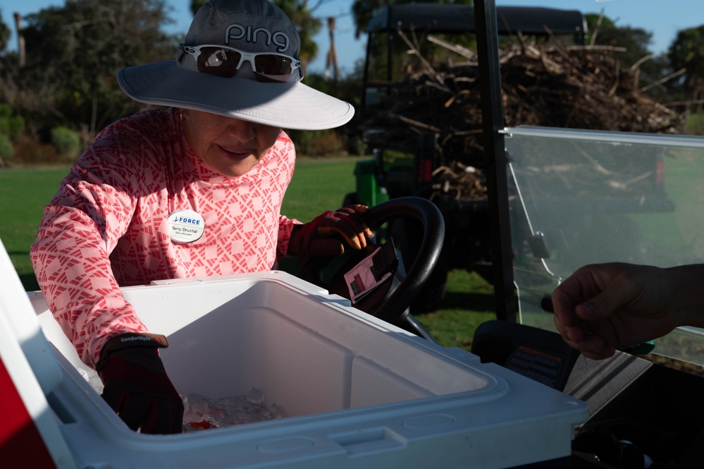 Volunteers and Staff clean up MacDill AFB Golf course following Hurricane Helene