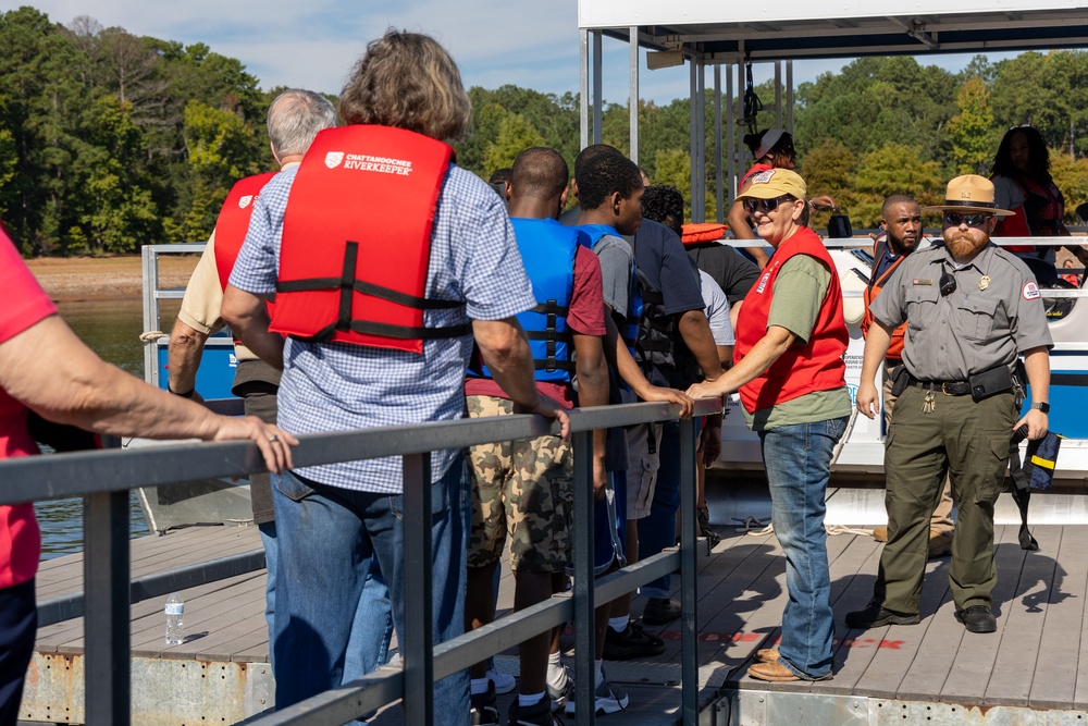 Park Ranger Mike Linville Assists Participants Boarding Pontoon Boats