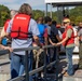 Park Ranger Mike Linville Assists Participants Boarding Pontoon Boats