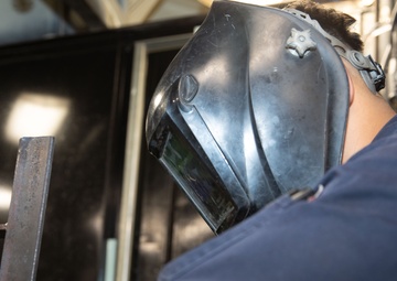 George Washington Sailor welds metal