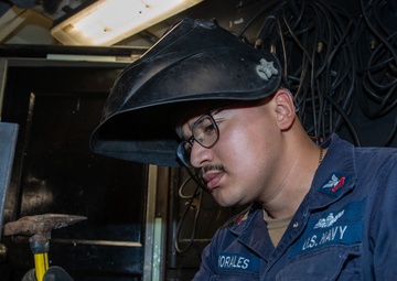 George Washington Sailor welds metal