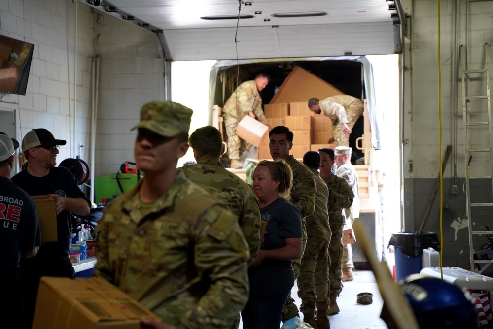 Active duty soldiers from the 82nd Airborne and the 20th Engineer Brigade from Fort Liberty, North Carolina, transported three 5-ton MTVs worth of food and water to the French Broad Fire and Rescue station.